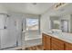 Bright bathroom featuring a separate shower, soaking tub, and a wood vanity at 9526 Vast Valley Ave, Las Vegas, NV 89148