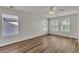 Sunlit bedroom boasts wood-look floors, large windows, and a ceiling fan for added comfort at 9526 Vast Valley Ave, Las Vegas, NV 89148