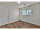 Bright bedroom with wood-look floors, a window, and a closet door at 9526 Vast Valley Ave, Las Vegas, NV 89148