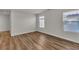 Bright bedroom with wood-look flooring and dual windows offering ample natural light at 9526 Vast Valley Ave, Las Vegas, NV 89148
