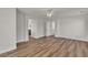 Open bedroom design featuring wood-look floors, white walls, and multiple doorways at 9526 Vast Valley Ave, Las Vegas, NV 89148