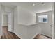 Bright and airy upper hallway featuring wood floors and a window with natural light at 9526 Vast Valley Ave, Las Vegas, NV 89148