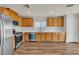 Bright kitchen with stainless steel appliances, wood cabinets and recessed lighting at 9526 Vast Valley Ave, Las Vegas, NV 89148