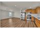 Modern kitchen with stainless steel appliances and a large open living space at 9526 Vast Valley Ave, Las Vegas, NV 89148