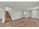Open-concept living room with wood-look flooring and access to the upper level at 9526 Vast Valley Ave, Las Vegas, NV 89148