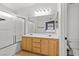 Bathroom with double vanity, large mirror, and a glass-enclosed shower at 9555 Belle Fountain Ave, Las Vegas, NV 89123