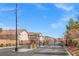 Community entrance with security gate, manicured landscaping, and access road into a secure neighborhood at 9555 Belle Fountain Ave, Las Vegas, NV 89123