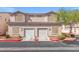 Inviting townhome featuring a two-car garage, tidy landscaping, and a well-maintained facade at 9555 Belle Fountain Ave, Las Vegas, NV 89123