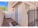 Cozy entrance featuring a well-lit doorway, secure gated entry, and a welcoming welcome mat at 9555 Belle Fountain Ave, Las Vegas, NV 89123