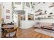 Bright open-concept living space with hardwood floors, modern decor, and access to the kitchen at 9555 Belle Fountain Ave, Las Vegas, NV 89123