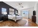 Spacious main bedroom with dark accent wall, four-poster bed, and ample natural light at 9555 Belle Fountain Ave, Las Vegas, NV 89123