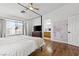 Bright main bedroom with hardwood floors, a four-poster bed, and an ensuite bathroom at 9555 Belle Fountain Ave, Las Vegas, NV 89123