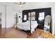 Main bedroom featuring a four-poster bed, wood floors, and neutral decor at 9555 Belle Fountain Ave, Las Vegas, NV 89123