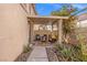 Covered patio with outdoor seating surrounded by desert landscaping at 9555 Belle Fountain Ave, Las Vegas, NV 89123