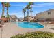 Community pool with beautiful palm trees and lounge chairs at 9555 Belle Fountain Ave, Las Vegas, NV 89123
