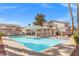 Community pool with clear blue water, lounge chairs, and pergola at 9555 Belle Fountain Ave, Las Vegas, NV 89123