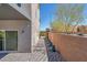 Exterior back yard pavers and landscaping, and exterior view of the home's sliding glass door at 9783 Hawk Crest St, Las Vegas, NV 89141