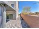 Exterior back yard with pavers, with covered awning and view of the home's sliding glass door at 9783 Hawk Crest St, Las Vegas, NV 89141