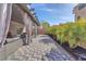 Expansive backyard patio with seating, dining, and palm trees, offering a perfect outdoor retreat at 9783 Hawk Crest St, Las Vegas, NV 89141