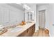 Bright bathroom featuring double sinks, granite countertops, and a stylish tiled shower at 9783 Hawk Crest St, Las Vegas, NV 89141