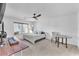 Bright bedroom with plush carpet, a ceiling fan, and a large window at 9783 Hawk Crest St, Las Vegas, NV 89141