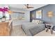 Cozy bedroom with a decorative dark accent wall, side tables, and a unique hanging light fixture at 9783 Hawk Crest St, Las Vegas, NV 89141