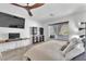 Bright bedroom showcasing a ceiling fan, a large TV, and neutral decor for a relaxing ambiance at 9783 Hawk Crest St, Las Vegas, NV 89141