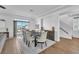 Elegant dining room with wood floors, a dark wood table, and patio access at 9783 Hawk Crest St, Las Vegas, NV 89141