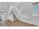 Bright entryway features wood-look tile floors and a staircase leading to the upper level at 9783 Hawk Crest St, Las Vegas, NV 89141