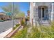 Inviting home exterior with a stone pathway, lush landscaping, and an elegant entrance at 9783 Hawk Crest St, Las Vegas, NV 89141