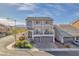 Stately two-story home with a balcony, well-manicured landscaping, and a three-car garage at 9783 Hawk Crest St, Las Vegas, NV 89141