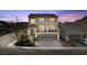 Elegant two-story home featuring a three-car garage and a charming front yard with lush landscaping at 9783 Hawk Crest St, Las Vegas, NV 89141