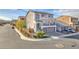 Elegant two-story home featuring a balcony, a well-kept lawn, and a three-car garage at 9783 Hawk Crest St, Las Vegas, NV 89141