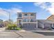 Charming two-story home featuring a three-car garage, balcony, and manicured front yard at 9783 Hawk Crest St, Las Vegas, NV 89141