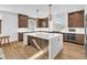 Kitchen area showcasing a central island, pendant lights and stainless-steel appliances at 9783 Hawk Crest St, Las Vegas, NV 89141