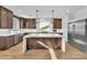 Kitchen featuring a large island with seating, modern appliances, and stylish pendant lights at 9783 Hawk Crest St, Las Vegas, NV 89141