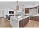 Modern kitchen with central island, pendant lights and open to the living area at 9783 Hawk Crest St, Las Vegas, NV 89141