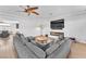 Open concept living room with modern fireplace and ceiling fan at 9783 Hawk Crest St, Las Vegas, NV 89141