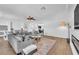 Bright living space boasting a fireplace, sectional sofa, wood-look flooring, and an open-concept design at 9783 Hawk Crest St, Las Vegas, NV 89141