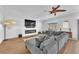 Inviting living room featuring a modern fireplace, tile flooring, and a large sectional sofa at 9783 Hawk Crest St, Las Vegas, NV 89141