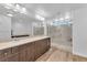 Luxurious primary bathroom with dual sinks, wood-look tile, and a spacious walk-in shower with a bench at 9783 Hawk Crest St, Las Vegas, NV 89141