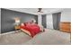 Comfortable main bedroom with a modern ceiling fan and dark accent wall at 9783 Hawk Crest St, Las Vegas, NV 89141