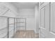 Walk-in closet features neutral carpet, wire shelving, and a door at 9783 Hawk Crest St, Las Vegas, NV 89141