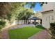 This backyard boasts a gazebo, artificial turf area, and mature shade trees at 2864 Cape Verde Ln, Las Vegas, NV 89128