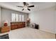 Bedroom with light walls and tile floor, light entering through plantation shutters at 2864 Cape Verde Ln, Las Vegas, NV 89128