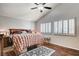 Bedroom with wood-look floors, ceiling fan, and shuttered windows for natural light at 2864 Cape Verde Ln, Las Vegas, NV 89128