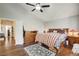 Bedroom with wood floors, ceiling fan, and shuttered windows for natural light at 2864 Cape Verde Ln, Las Vegas, NV 89128