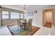 Cozy dining room with a glass table set and natural light from the windows at 2864 Cape Verde Ln, Las Vegas, NV 89128