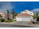 Charming two-story home featuring a red tile roof and a spacious two-car garage at 2864 Cape Verde Ln, Las Vegas, NV 89128