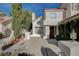 Charming two-story home featuring a red tile roof and lush front yard landscaping at 2864 Cape Verde Ln, Las Vegas, NV 89128